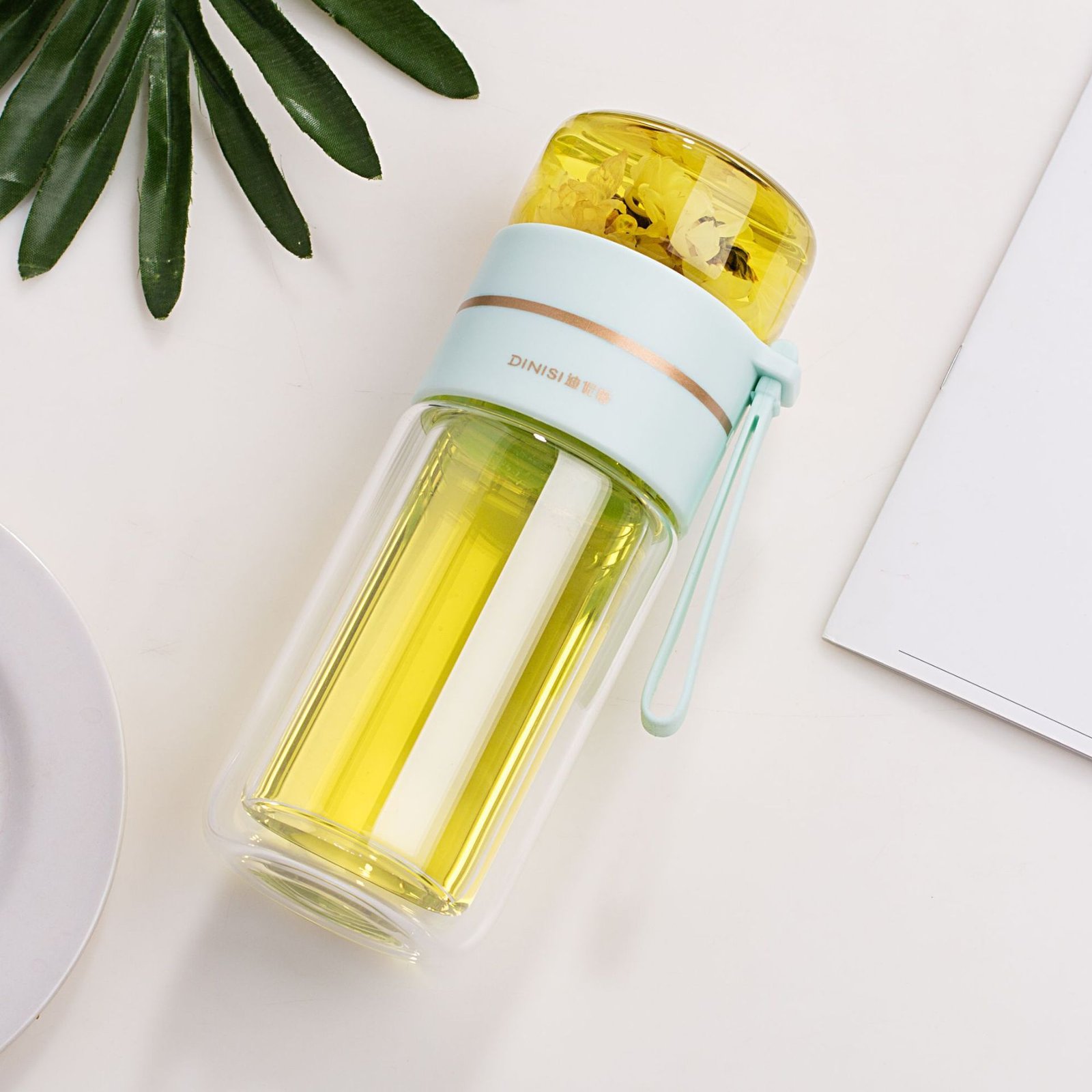 The Glass Tea Bottle placed on a desk, highlighting its elegant and modern look.